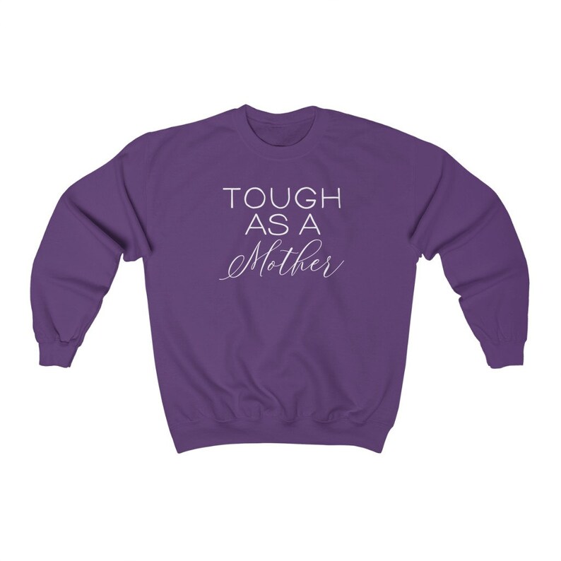 May include: Purple sweatshirt with the text "TOUGH AS A MOTHER" in white.