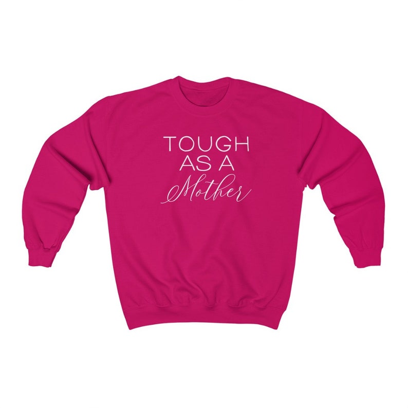May include: A pink sweatshirt with the text "TOUGH AS A MOTHER" in white lettering.