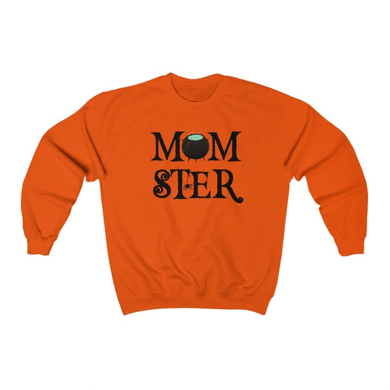 May include: Orange sweatshirt with black text that reads "MOMSTER" with a cauldron and spider graphic.