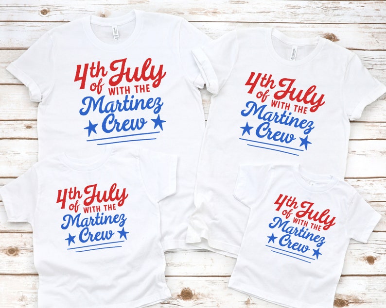 May include: Four white t-shirts with red and blue text that reads "4th July of with the Martinez Crew" and a blue star on each side of the word "Crew".