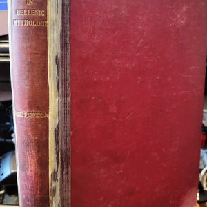 May include: A red hardcover book with the title "Semitic Influence in Hellenic Mythology" by Robert Brown Jr. on the spine.