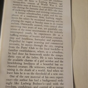 May include: A vintage book cover with a black and white image of a tall, thin obelisk. The title of the book is "The Black Obelisk" by Erich Maria Remarque. The book cover also includes the text "Translated by Denver Lindley".