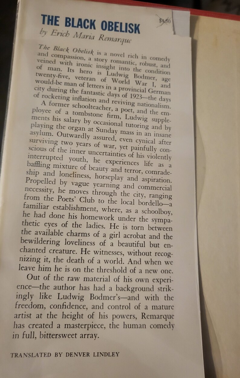 May include: A vintage book cover with a black and white image of a tall, thin obelisk. The title of the book is "The Black Obelisk" by Erich Maria Remarque. The book cover also includes the text "Translated by Denver Lindley".