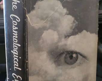 May include: A black and white book cover with the title "The Cosmological Eye" by Henry Miller. The cover features a close-up of an eye looking out from behind a cloud.