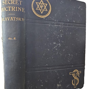 May include: A vintage, dark blue book titled "The Secret Doctrine" by Blavatsky, Volume III, published in 1897 by the Theosophical Publishing Society. The cover features gold embossed text and symbols, including a star within a circle.