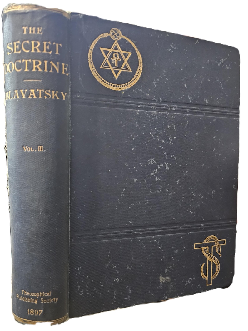 May include: A vintage, dark blue book titled "The Secret Doctrine" by Blavatsky, Volume III, published in 1897 by the Theosophical Publishing Society. The cover features gold embossed text and symbols, including a star within a circle.