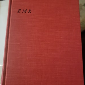 May include: A red hardcover book with the letters "EMR" printed in black on the front cover.