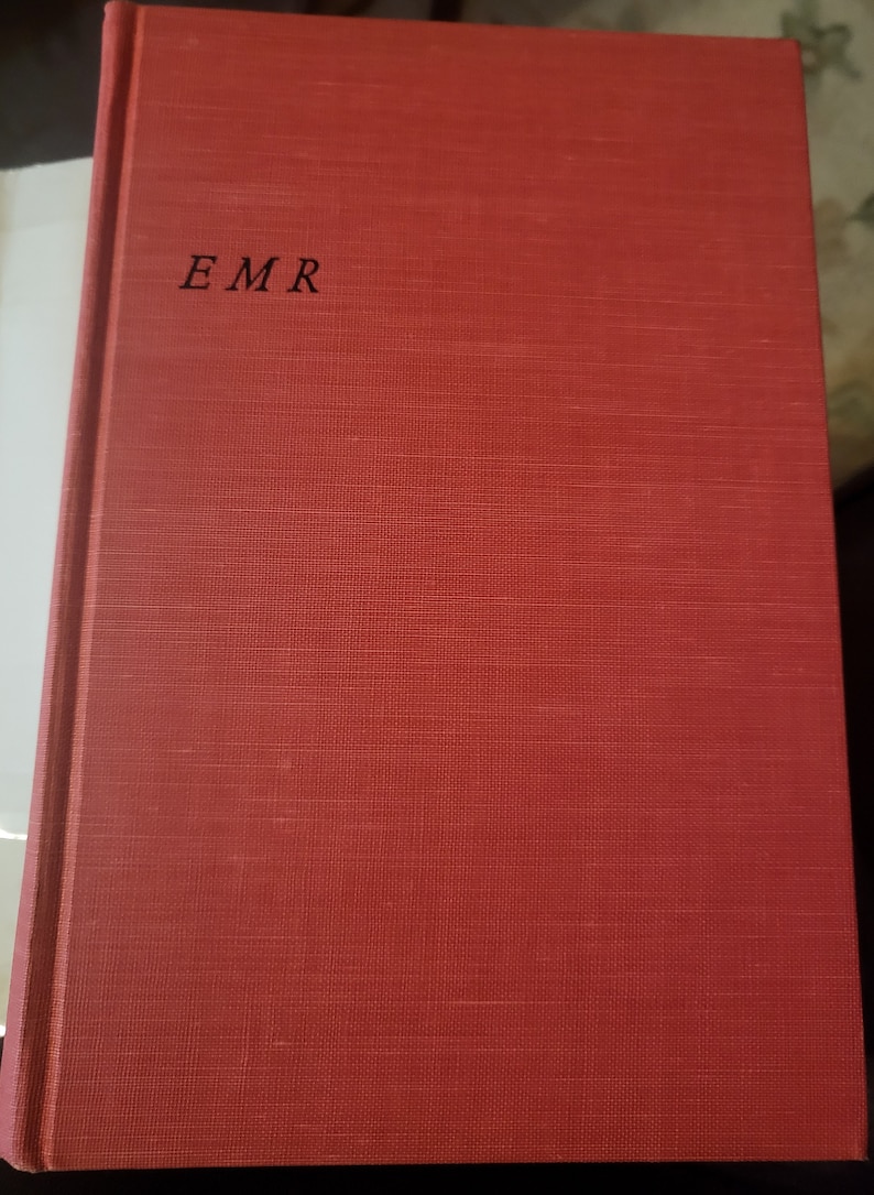 May include: A red hardcover book with the letters "EMR" printed in black on the front cover.