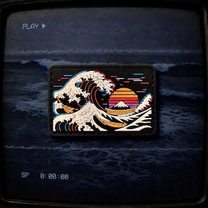 May include: A rectangular patch featuring a stylised graphic of a large crashing wave, a mountain peak, and a multi-coloured sunset. The design uses bold lines in white, orange, red, and purple against a black background, depicting a boat on water.