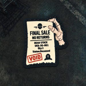 May include: A rectangular patch with a cream-coloured background and black border. It features a skeleton hand holding the top edge. Text reads: FINAL SALE, NO RETURNS, DEAD STOCK, SKU: DS-001, Qty:1, Status:Deceased. Includes a skull icon and a red VOID stamp.