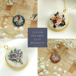 May include: Four polymer clay flower bouquets on gold chains. Each bouquet is a different color and style. The text "The Watermark Design CUSTOM POLYMER CLAY BOUQUETS Click for more info" is on a gray background.