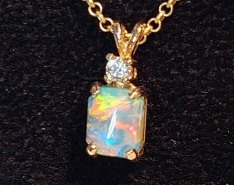 Bright and colorful opal pendant with diamond in 14k gold setting with 14k gold 18 inch oval chain