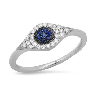 May include: A silver ring with a blue sapphire eye surrounded by a halo of white diamonds.