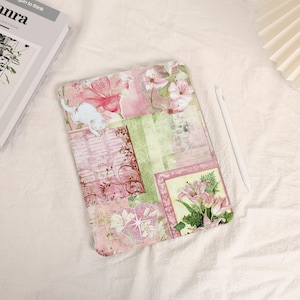 May include: A rectangular tablet case featuring a collage design with pink and green floral patterns, a white cat illustration, script text, and a heart shape. The case is decorated with various botanical motifs and vintage-style paper textures.
