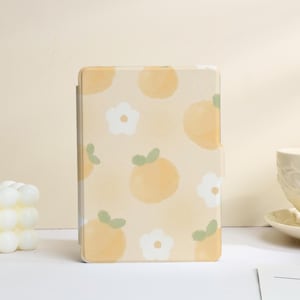 May include: A light beige tablet case with a repeating pattern of orange-yellow fruit and white flowers. The case is rectangular and has a smooth finish. The design is reminiscent of a watercolor painting.