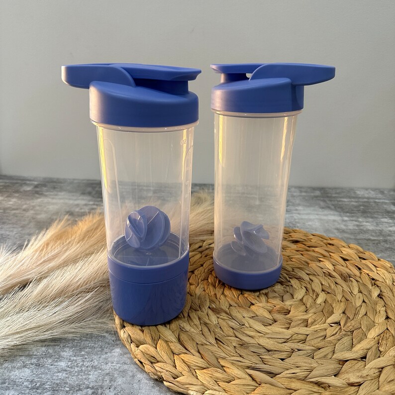 May include: Two blue plastic shaker bottles with clear containers and a blue mixing ball inside. The bottles have a flip top lid and a carrying handle.