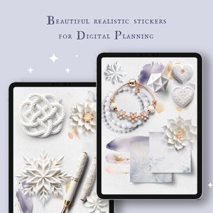 May include: A digital tablet screen displaying a collection of white and gold decorative stickers, including a snowflake, a knot, a flower, a heart, a bracelet, and a geometric shape. The stickers are arranged on a white background with watercolor washes in shades of blue and purple.
