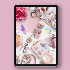 May include: A pink tablet screen displaying a flat lay of various pink and gold decorative items, including a flower, a key, a lamp, a candle, a clock, and a pair of scissors.