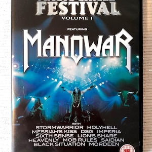 May include: A black DVD case for the Magic Circle Festival Volume I featuring Manowar. The cover shows a live concert scene with blue stage lighting and a list of bands including Stormwarrior, Holyhell, Messiah's Kiss, and others, with a 15 rating.