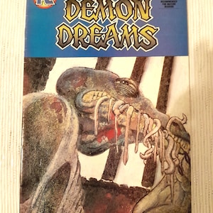 May include: A vintage comic book titled "Demon Dreams" by Arthur Suydam. The cover features a grotesque creature with exposed teeth and tentacles, set against a blue background. The comic is labeled No. 2 and is recommended for mature readers.