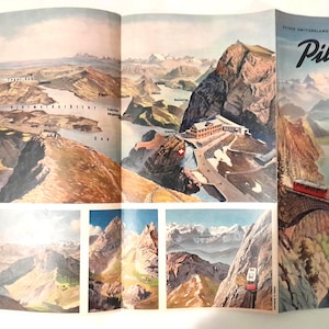 May include: A vintage travel brochure featuring scenic views of the Swiss Alps. The brochure unfolds to reveal detailed illustrations of mountain ranges, lakes, and a red train crossing a stone bridge. Text includes "Pilatus" and other place names.