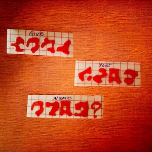 May include: Three white squares with red letters on a red background. The top square says "Give your name?" The middle square says "Your name?" The bottom square says "Give your name?"