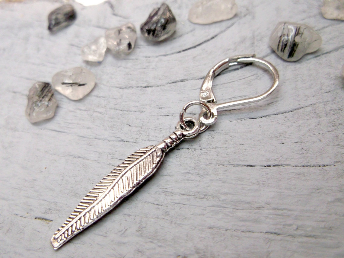 One feather earring Symbolic meaning Feather dangle Men Etsy