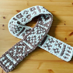 May include: A brown and white knitted scarf with a chunky knit pattern.