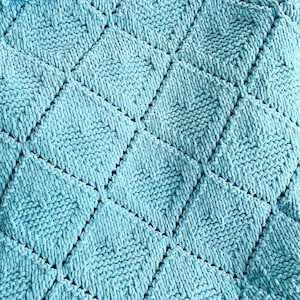 May include: A teal blue knitted blanket with a diamond pattern.