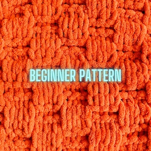 May include: A close-up image of a bright orange, fluffy, crocheted blanket with the text "BEGINNER PATTERN" in a light blue font.