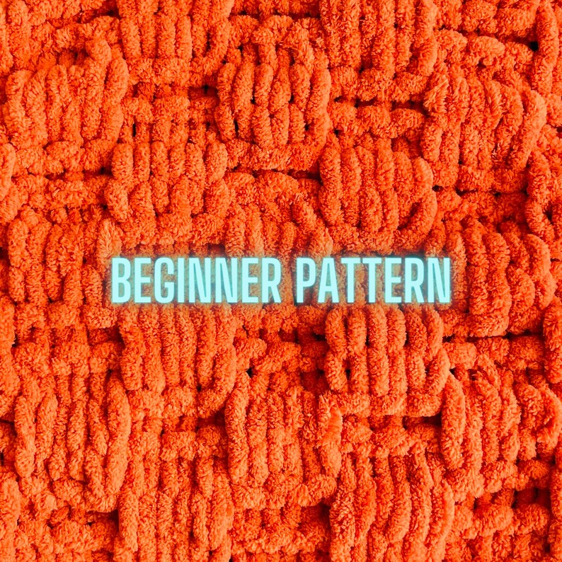 May include: A close-up image of a bright orange, fluffy, crocheted blanket with the text "BEGINNER PATTERN" in a light blue font.