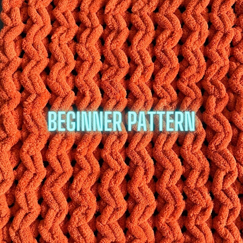 May include: Close-up of a woven orange fabric with a textured, wavy pattern. The fabric has a "BEGINNER PATTERN" label.
