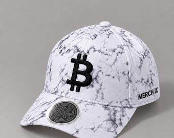 May include: A white baseball cap with a black marble pattern. The front features a large, embroidered black Bitcoin symbol. The side displays the text MERCH IX in black, and a circular sticker with the MERCH IX logo is on the brim.