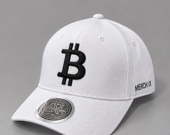 May include: A white baseball cap featuring a prominent black embroidered Bitcoin symbol on the front panel. The side of the cap displays the text MERCH IX in black, and a circular silver sticker with the MERCH IX logo is on the brim.