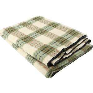 May include: Folded blanket with a cream-colored base and a green and brown plaid pattern. The blanket has a black border and is made of a soft, textured material. The plaid design is a classic style, suitable for home decor.