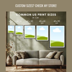 May include: Five framed landscape prints with black borders, depicting a blue sky, white clouds, and green hills. The prints are displayed above a sofa. Text reads: "CUSTOM SIZES? CHECK MY STORE! COMMON US PRINT SIZES IN CM".
