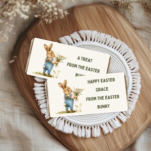 May include: Two Easter bunny themed gift tags with a bunny holding flowers. The top tag says "A treat from the Easter bunny". The bottom tag says "Happy Easter Grace from the Easter bunny".