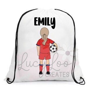 May include: White drawstring bag with black drawstrings. The bag has a black and white illustration of a girl in a red soccer jersey holding a soccer ball. The text "EMILY" is printed in black at the top of the bag.