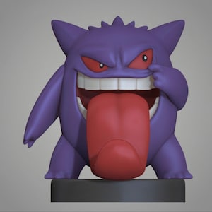 May include: A purple Gengar figurine with red eyes and a large red tongue. The figure is smiling, with its tongue sticking out and one hand pulling at its cheek. The figurine is on a gray base.