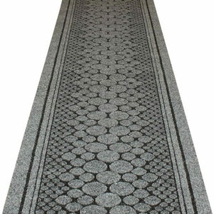 May include: A grey and black patterned non-slip runner rug with a pebble design. The rug has a textured surface and is ideal for use in high-traffic areas.