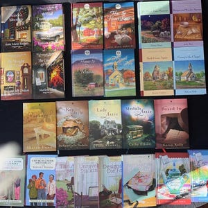 May include: A collection of 20 paperback books with various titles and authors. The books are arranged in three rows, with the top row containing 6 books, the middle row containing 8 books, and the bottom row containing 6 books. The books are all different colors and have different designs on their covers.