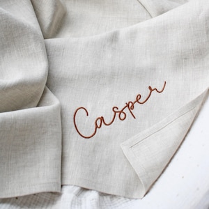 Natural linen baby blanket with name embroidery.