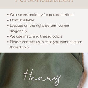 May include: An olive green fabric with the name "Henry" embroidered in white cursive script. The image also includes text about personalization, including embroidery, font availability, and thread colors.