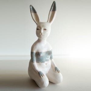 Ceramic statue of hare bodypositive girl, whimsical guitar body rabbit character, weird bunny sculpture decor
