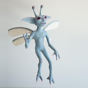 May include: A light blue fantasy creature figurine with large ears, antennae, and wings. The figurine has a slender build, with a smiling expression and is posed with one hand raised. The wings are white with a light blue outline.
