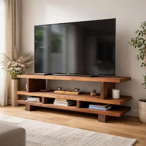 May include: A dark brown wooden TV stand with a tiered design. The stand has multiple shelves for storage and display, with a large black television on top. The stand is in a living room setting.