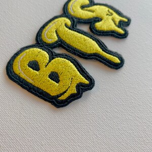 thumbnail image 2 of BTS K-Pop Logo Embroidered Iron On Patch | 2.5x3 Inch | Music Craft Patch 2 of 5