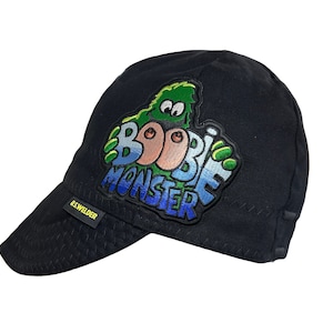 May include: Black welding cap with a green, blue, and yellow Boobie Monster patch. The cap has a U.S. Welder logo on the side.