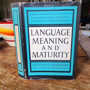 May include: A blue and black hardcover book titled "Language, Meaning and Maturity" edited by S.I. Hayakawa, author of "Language in Thought & Action".