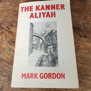 May include: A vintage book titled "THE KANNER ALIYAH" by Mark Gordon. The cover features a black and white illustration of a person and a street scene. The title and author's name are in red.